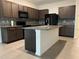 Modern kitchen with dark brown cabinets and granite countertops at 3005 Suncoast Blend Dr, Odessa, FL 33556