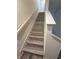 Modern staircase with light grey wood-look laminate at 3005 Suncoast Blend Dr, Odessa, FL 33556