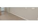 Neutral-toned hallway with tile flooring and white baseboards at 3241 Feather Haven Pl, Brandon, FL 33511