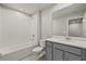 Clean bathroom with a tub, toilet, vanity, and mirror at 3243 Feather Haven Pl, Brandon, FL 33511