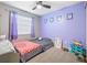 Cozy bedroom with lavender walls and twin-size bed at 3411 28Th E St, Bradenton, FL 34208