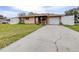 Tan one-story house with a white garage door and landscaped lawn at 3411 28Th E St, Bradenton, FL 34208