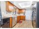 Kitchen with wood cabinets, stainless steel dishwasher, and wood floors at 3411 28Th E St, Bradenton, FL 34208