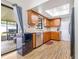 Kitchen features wood cabinets, stainless steel appliances, and backyard access at 3411 28Th E St, Bradenton, FL 34208