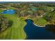 Aerial view of lush green golf course with water features at 36750 Us Highway 19 # 21-301, Palm Harbor, FL 34684