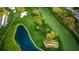 Aerial view of golf course with pond and landscaping at 36750 Us Highway 19 # 21-301, Palm Harbor, FL 34684