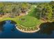 Aerial view of a golf course with a pond featuring a Copperhead sign at 36750 Us Highway 19 # 21-301, Palm Harbor, FL 34684