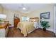 Bright bedroom with wood floors and ample closet space at 36750 Us Highway 19 # 21-301, Palm Harbor, FL 34684