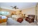 King-size bedroom with ensuite bathroom and a ceiling fan at 36750 Us Highway 19 # 21-301, Palm Harbor, FL 34684