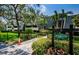 Building entrance with signage and landscaping at 36750 Us Highway 19 # 21-301, Palm Harbor, FL 34684
