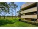 Building exterior with golf course view and balcony at 36750 Us Highway 19 # 21-301, Palm Harbor, FL 34684