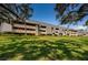 Exterior of building with landscaping and trees at 36750 Us Highway 19 # 21-301, Palm Harbor, FL 34684