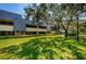 Exterior view of building with landscaping and walkway at 36750 Us Highway 19 # 21-301, Palm Harbor, FL 34684