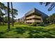Exterior view of building with lush green lawn at 36750 Us Highway 19 # 21-301, Palm Harbor, FL 34684