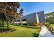 Exterior of building showcasing landscaping and walkway at 36750 Us Highway 19 # 21-301, Palm Harbor, FL 34684