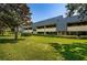 Exterior of building with landscaping and grassy area at 36750 Us Highway 19 # 21-301, Palm Harbor, FL 34684