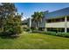 Exterior of building with lush green landscaping at 36750 Us Highway 19 # 21-301, Palm Harbor, FL 34684
