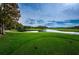 Golf course fairway with pond and trees at 36750 Us Highway 19 # 21-301, Palm Harbor, FL 34684