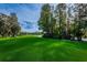Golf course with trees, pond, and bridge at 36750 Us Highway 19 # 21-301, Palm Harbor, FL 34684