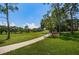 Golf course path with green grass and trees at 36750 Us Highway 19 # 21-301, Palm Harbor, FL 34684