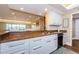 Modern kitchen featuring white cabinets, granite countertops, and a breakfast bar at 36750 Us Highway 19 # 21-301, Palm Harbor, FL 34684