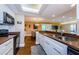 Eat-in kitchen boasting granite counters, white cabinets, and black appliances at 36750 Us Highway 19 # 21-301, Palm Harbor, FL 34684