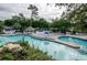 Expansive pool area with numerous lounge chairs at 36750 Us Highway 19 # 21-301, Palm Harbor, FL 34684