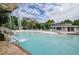 Inviting pool area with a cabana and waterfall at 36750 Us Highway 19 # 21-301, Palm Harbor, FL 34684