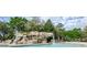 Resort-style pool with a large rock waterfall feature at 36750 Us Highway 19 # 21-301, Palm Harbor, FL 34684