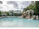 Large resort-style pool with a waterfall and lounge chairs at 36750 Us Highway 19 # 21-301, Palm Harbor, FL 34684