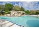 Large resort-style pool with a waterfall feature at 36750 Us Highway 19 # 21-301, Palm Harbor, FL 34684