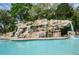 Relaxing waterfall feature next to the pool at 36750 Us Highway 19 # 21-301, Palm Harbor, FL 34684