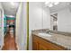 Guest bathroom with granite vanity and view of kitchen at 3817 W Platt St # 306, Tampa, FL 33609