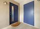 Condo building entrance with blue doors and a doormat at 3817 W Platt St # 306, Tampa, FL 33609