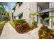 Well-maintained building exterior with landscaped grounds and walkway at 3817 W Platt St # 306, Tampa, FL 33609