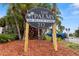 Community sign for The Palms of Beach Park, a complex with lush landscaping and convenient parking at 3817 W Platt St # 306, Tampa, FL 33609