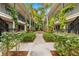Community courtyard with tropical landscaping and fountain at 3817 W Platt St # 306, Tampa, FL 33609