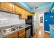 Kitchen features stainless steel appliances and wood cabinets at 3817 W Platt St # 306, Tampa, FL 33609