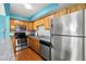 Stainless steel appliances and wood cabinets in this galley kitchen at 3817 W Platt St # 306, Tampa, FL 33609