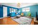 Bright living room with blue walls, hardwood floors, and comfy furniture at 3817 W Platt St # 306, Tampa, FL 33609