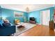 Living room with hardwood floors, blue walls, and a TV at 3817 W Platt St # 306, Tampa, FL 33609