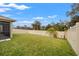 Backyard with grassy lawn and vinyl fence at 3946 Postmark Lake Pl, Seffner, FL 33584