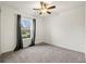 Bright bedroom with gray carpeting and ceiling fan at 3946 Postmark Lake Pl, Seffner, FL 33584