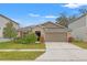 Single-story home with attached garage and well-maintained lawn at 3946 Postmark Lake Pl, Seffner, FL 33584
