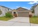 Two-car garage and front yard of charming single-Gathering home at 3946 Postmark Lake Pl, Seffner, FL 33584