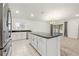 Open kitchen with island, granite countertops, and stainless steel appliances at 3946 Postmark Lake Pl, Seffner, FL 33584