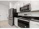 Modern kitchen featuring stainless steel appliances and granite countertops at 3946 Postmark Lake Pl, Seffner, FL 33584