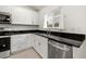 White cabinets, granite countertops, and stainless steel appliances in kitchen at 3946 Postmark Lake Pl, Seffner, FL 33584