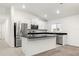 Modern kitchen with island, granite countertops and stainless steel appliances at 3946 Postmark Lake Pl, Seffner, FL 33584
