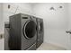 Laundry room with washer and dryer, and overhead shelving at 3946 Postmark Lake Pl, Seffner, FL 33584
